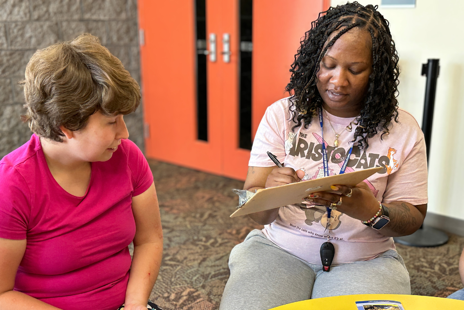 A client works with a staff member at an advocacy event