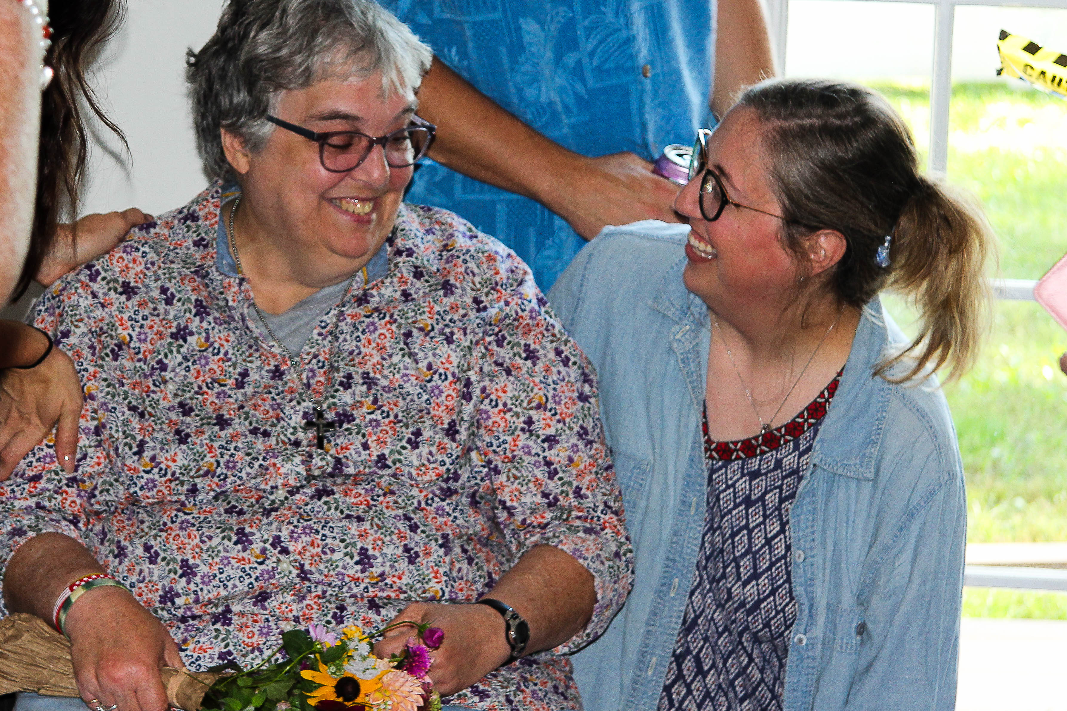 A Direct Support Professional smiles at a Group Home resident