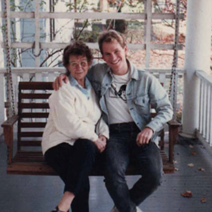 Ray Ratke and his mother sit on a porch swing