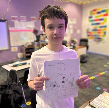Maddox holds up his cartoon