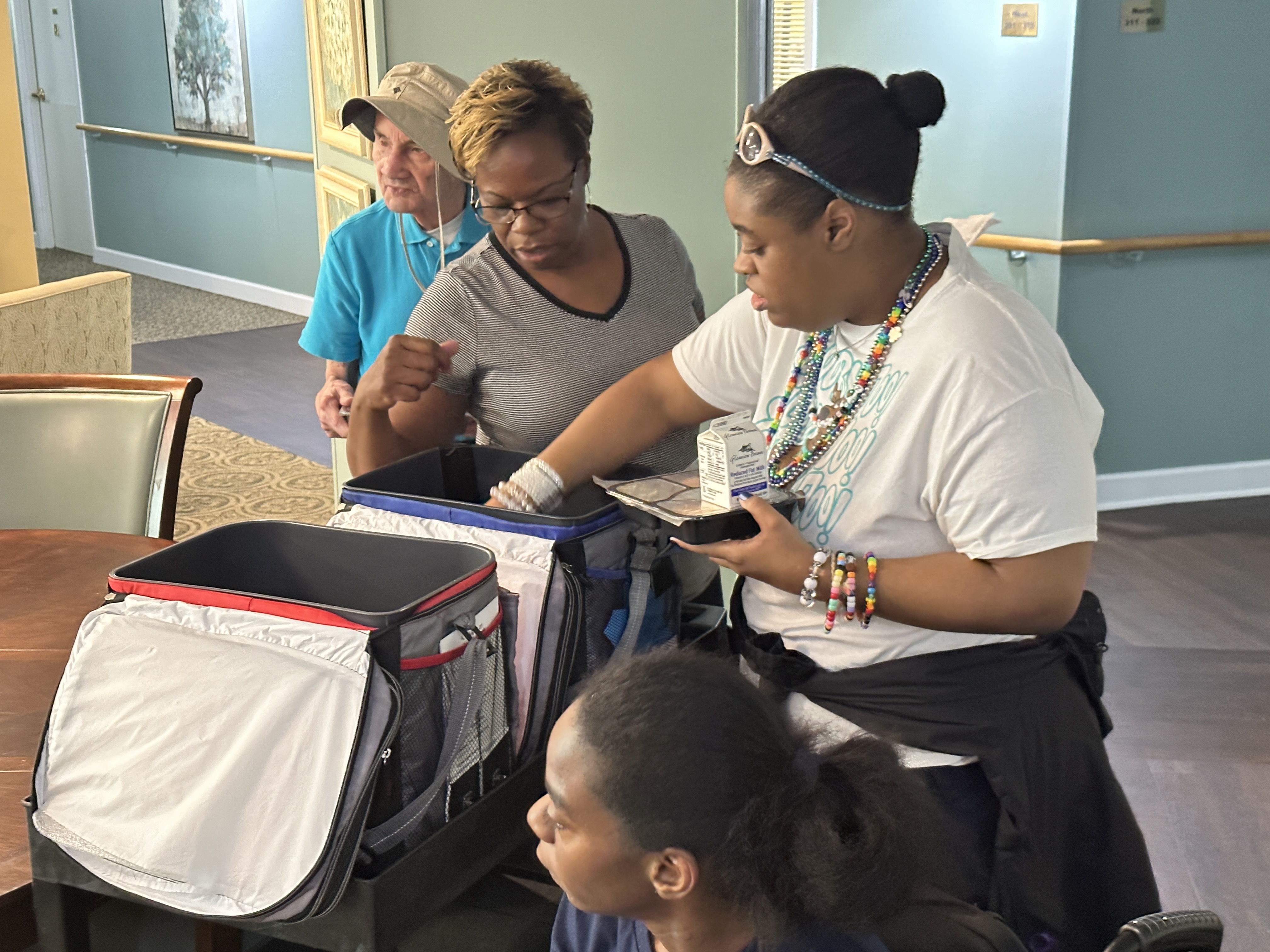 Volunteers from Lynchburg Day Support sort through coolers