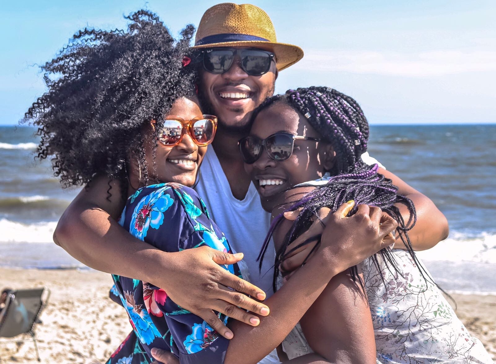 A family hugs on the beach