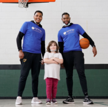 Levi, Sadie, and Mikeal  pose together in the gym