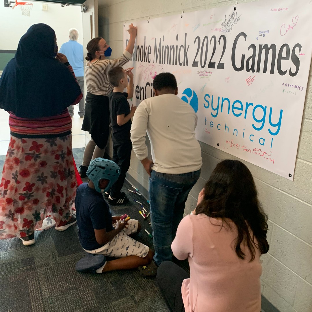 Students, staff, and teachers sign the Roanoke Minnick 2022 Games banner