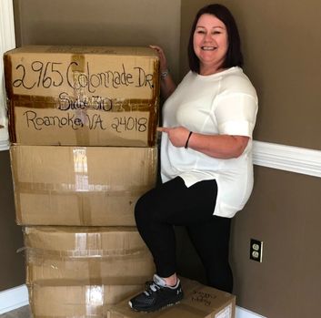 Jessie poses with moving boxes