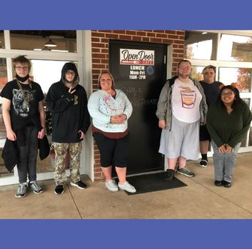 Students from Wytheville Minnick stand in front of a door that says Open Door Cafe