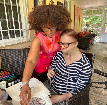 Darlene helps Linda at an outdoor table