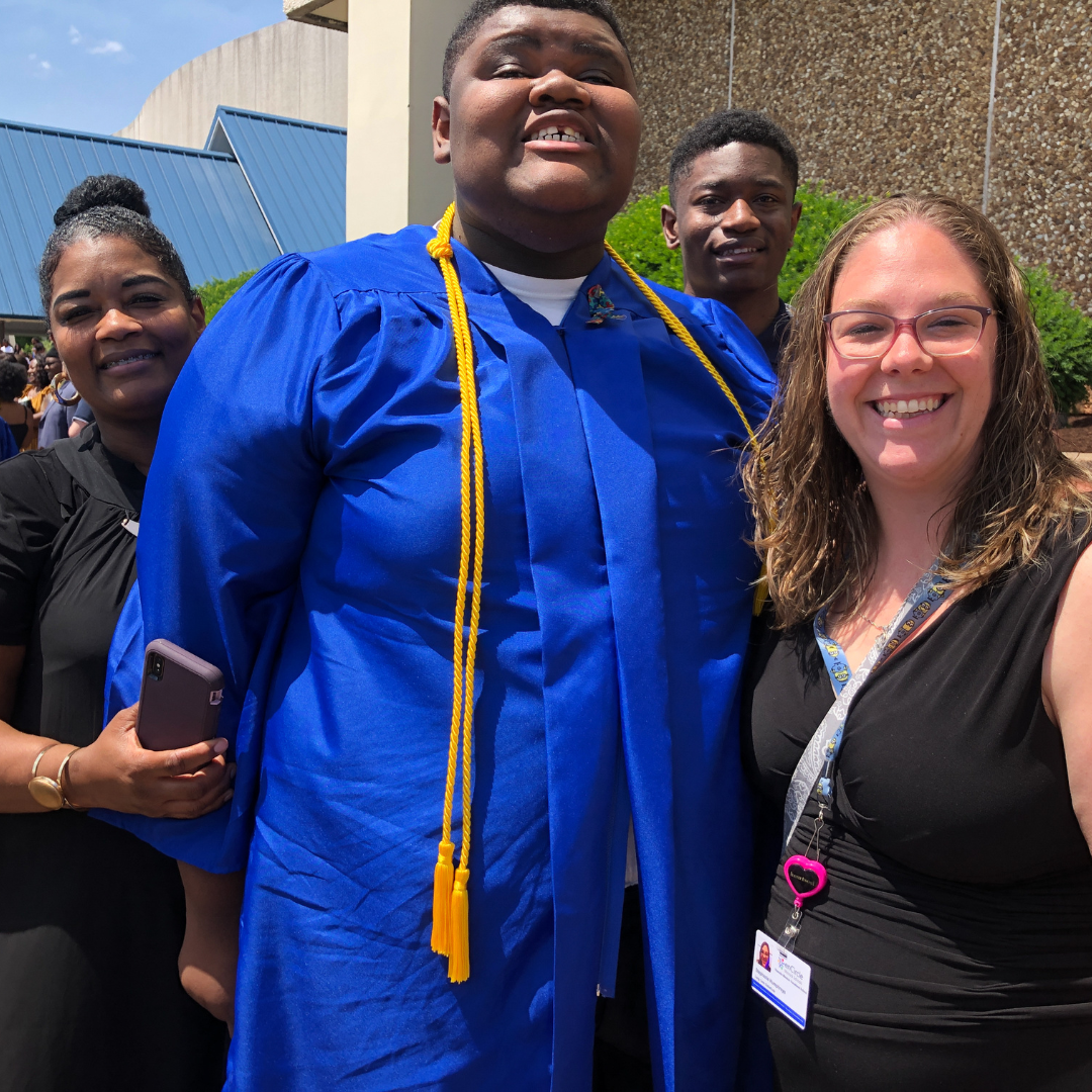 Urias' mom, Urias, Uriah, and Assistant Teach Stephanie Humphreys smile at the camera